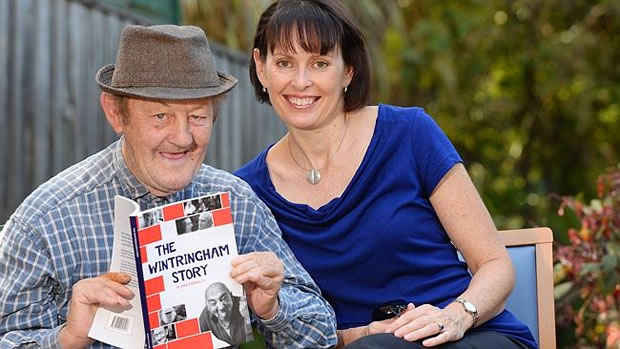 Elaine Farrelly with Wintringham, Flemington resident, Geoffrey Wolter and a copy of her new Book - Herald Sun